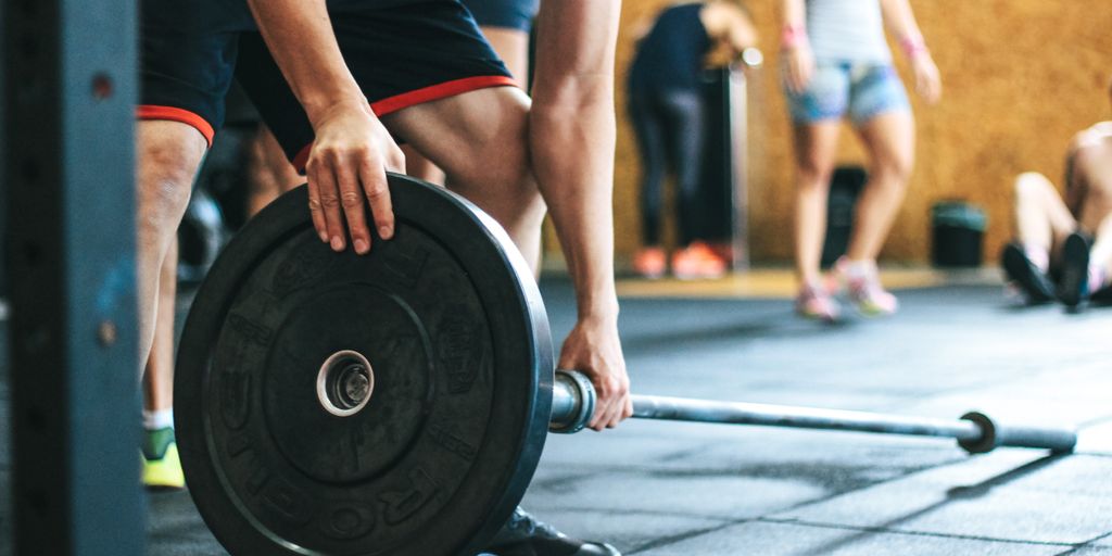 people exercising in a gym with a focus on weight loss and fitness