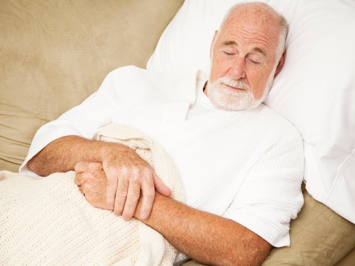 person sleeping peacefully with a tape measure and healthy food nearby