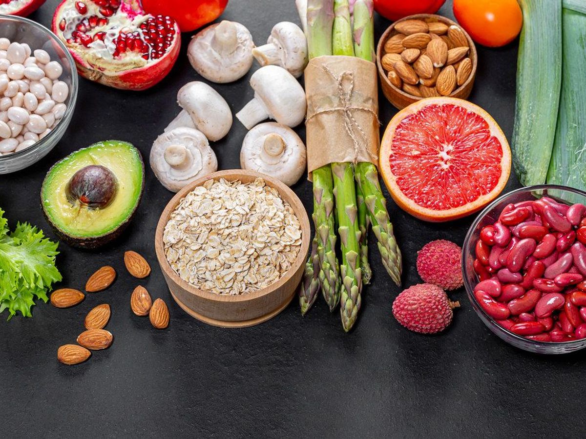 healthy lifestyle books on a wooden table with fruits and vegetables