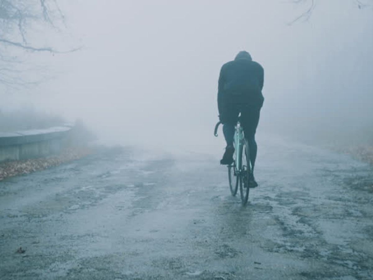 person cycling on a scenic trail for weight loss