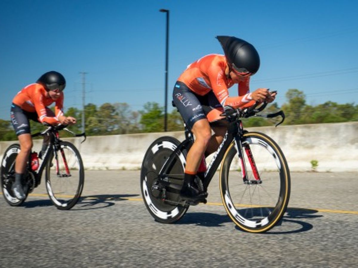 cyclist riding a bike on a scenic outdoor trail and another cyclist on a stationary bike indoors